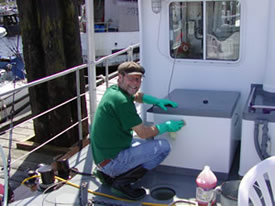 Scrubbing the decks to keep the Coastal Messenger looking new.