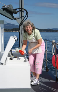 Getting produce out of the deck box on the Coastal Messenger.