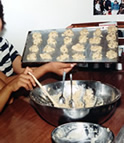 Kids making cookies in Coastal Messenger galley.
