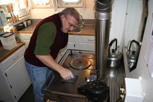 Cleaning the galley range.