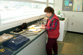 Writing letters at the laundromat.