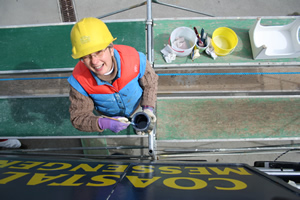 Painting Coastal Messenger name on stern.