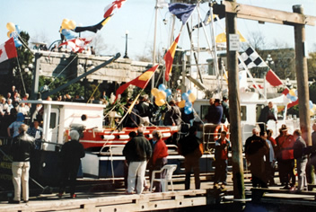 Commissioning service of the new Coastal Messenger in the Victoria Inner Harbour, all decorated with coloured flags.